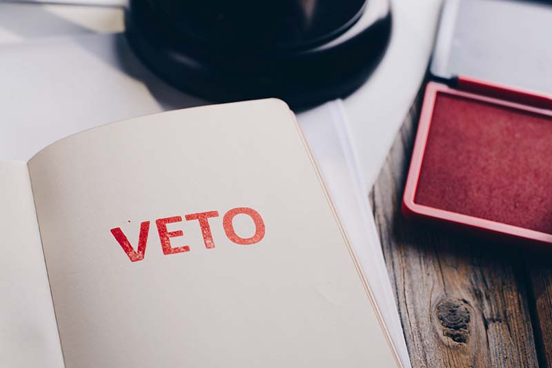 Red veto stamp in notepad - law office conceptRed veto stamp in notepad - law office concept