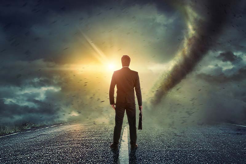Businessman watching a tornado. Concept for success.