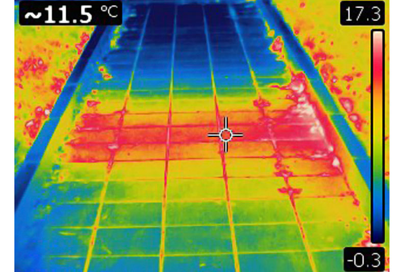 Infrared image of heated surface from underground hot water pipe. Colors represent various temperatures, defined with rainbow Celsius scale on right side of image. Temperature on upper left corner is a temperature of a point where cursor is. Photo is taken with Flir T420 infrared camera.