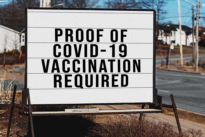 Roadside signage for a store that requires proof of Covid-19 vaccination.