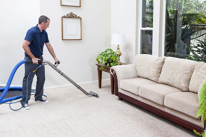 man cleaning carpet