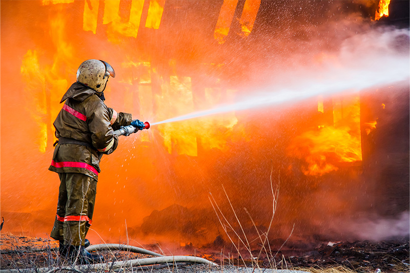 firefighter putting out a building fire