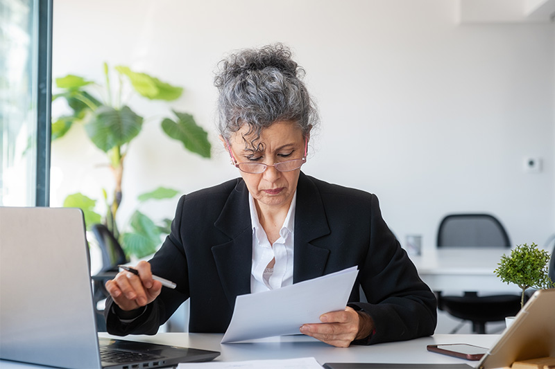 mature woman looking at a contract