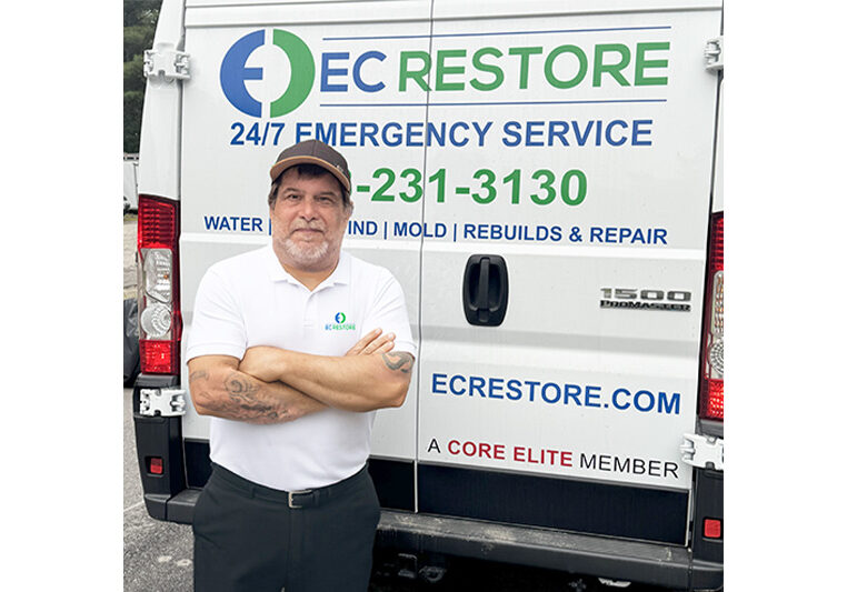 Tom Sousa standing in front of EC Restore vehicle