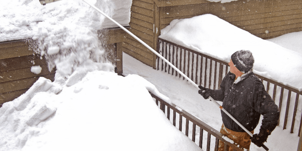 Figure 3 - Example of a roof rake being used to remove snow accumulation.