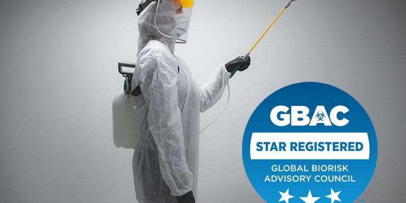 Scientist holding chemical sprayer for sterilization and decontamination of viruses, germs, pests, infectious diseases.