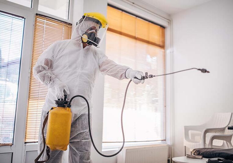 One man, man in protective suit disinfecting and spraying every room in the building alone.