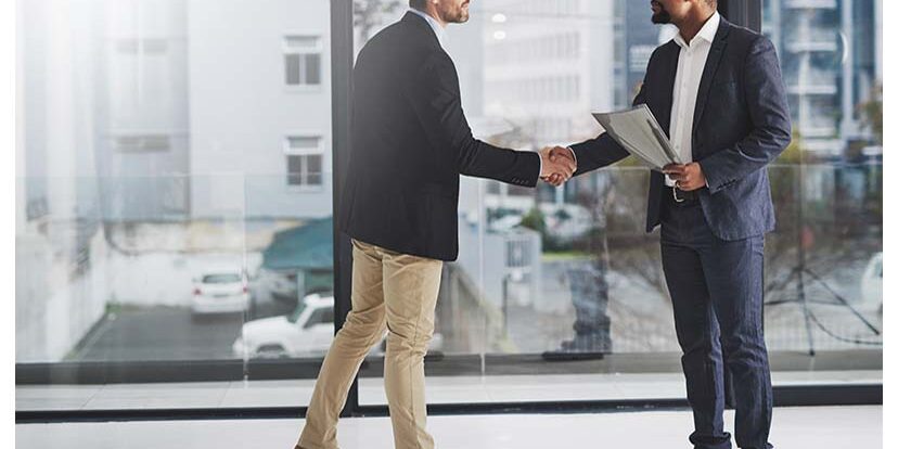 Combining corporate talent Shot of two businessmen shaking hands at work