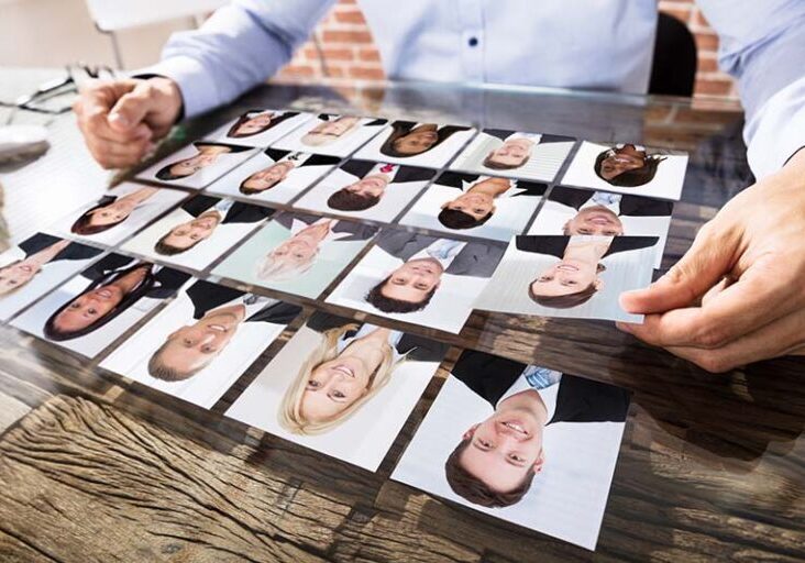 Close-up Of A Businessman Making Candidate Selection Over The Desk At Workplace