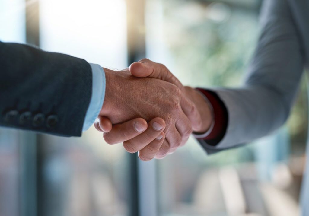 Cropped shot of two unrecognizable businessmen shaking hands after making a deal in the office