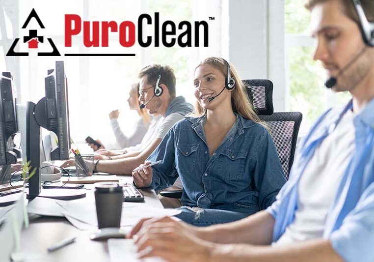 Young handsome male customer support phone operator with headset working in call center.