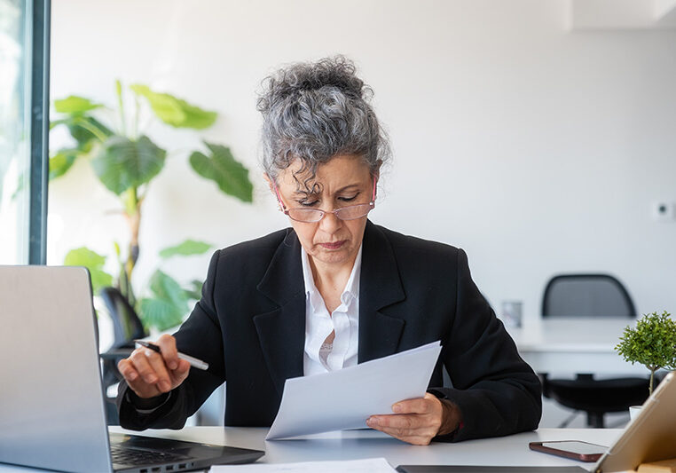mature woman looking at a contract