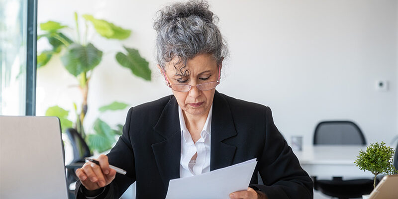 mature woman looking at a contract