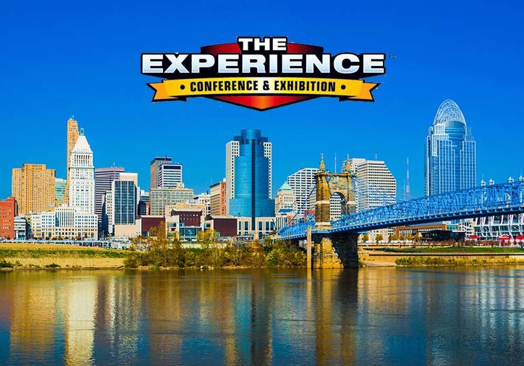 View of the Cincinnati downtown skyline with the John A. Roebling Bridge and the Ohio River in the foreground.