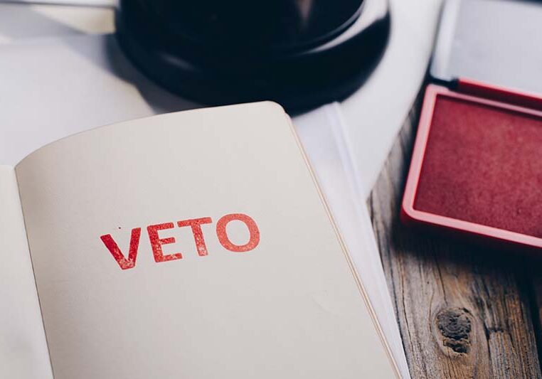 Red veto stamp in notepad - law office conceptRed veto stamp in notepad - law office concept