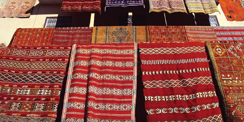 banner-image-moroccan-rugs-hanging-on-railings