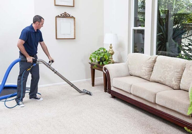 man cleaning carpet