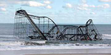 epa03453939 A roller coaster is left stranded in the ocean after Casino Pier was destroyed by Hurricane Sandy, in Seaside Heights, New Jersey, USA, 31 October 2012. The US East Coast was to start picking up the pieces on 31 October after superstorm Sandy left at least 33 people dead and damage estimated in the billions of dollars. New York Mayor Michael Bloomberg said the largest US city was going 'back to business' and bus routes would be fully reopened 31 October. The subway would probably take another four or five days to resume operations, he said late 30 October. Some flights were to also resume. US President Barack Obama visited New Jersey on 31 October with the state's governor, Chris Christie, for a first-hand impression of the damage.  EPA/MICHAEL REYNOLDS ** Usable by LA Only **