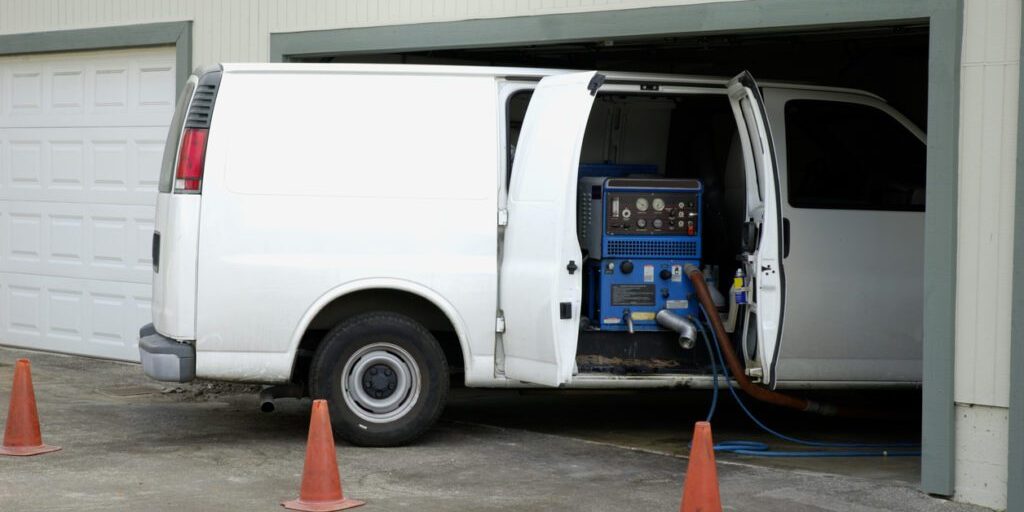 Carpet cleaning van inside garage's apartment.