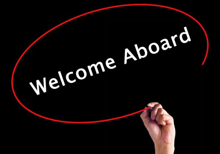 Hand Writing Welcome Aboard with a marker over transparent board