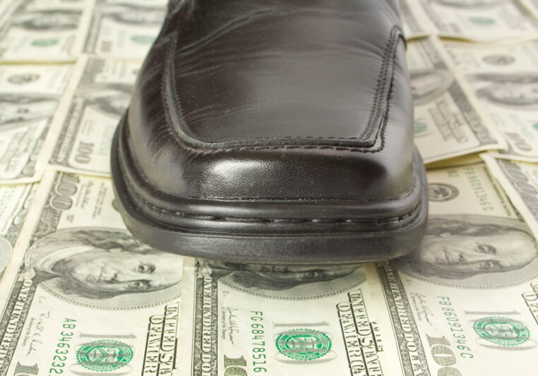 Money concept. Shoe on dollar floor