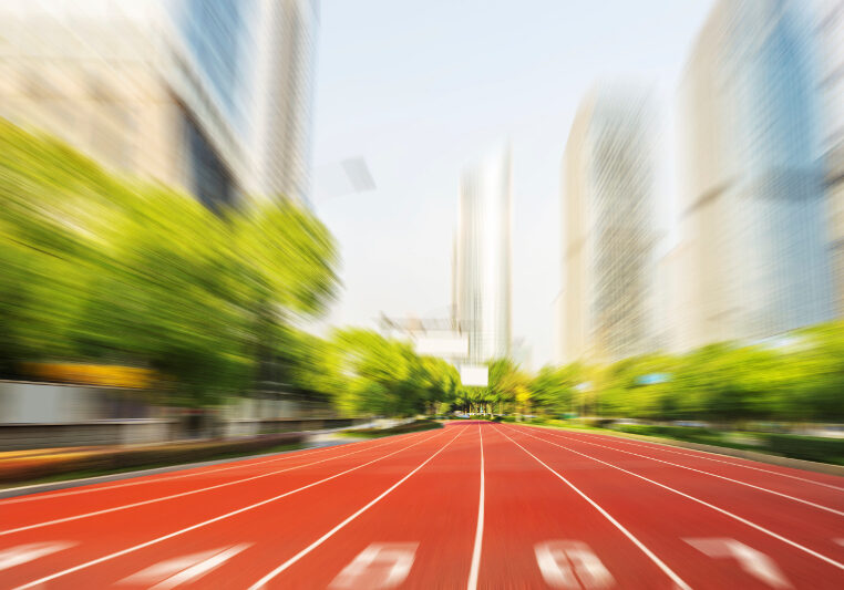 running race line in modern city road with cityscape as background,Modern business competition concept.