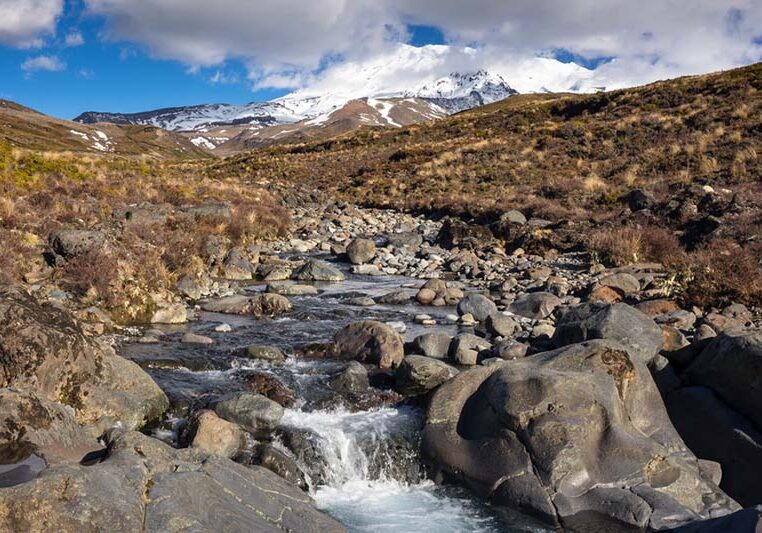 A stream flowing off the side of Mount Ruapehu in spring, at the top of Taranaki Falls in Tongariro National Park, New Zealand.