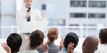 Business team applauding a mature businessman